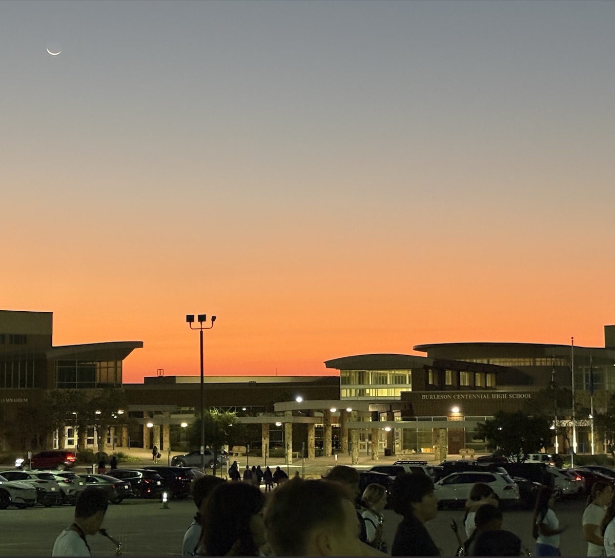Sunset behind a school building.